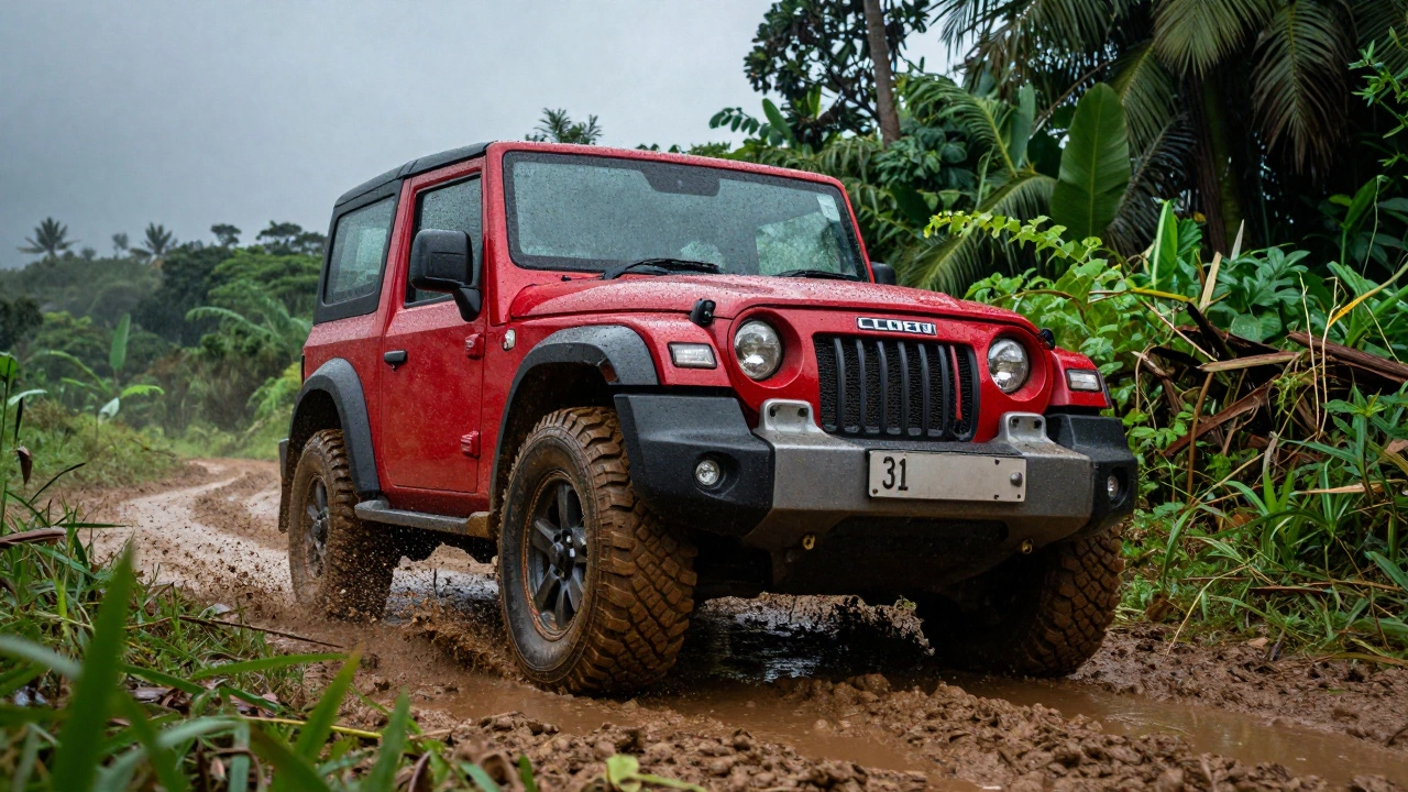 A rugged red Mahindra Thar driving through muddy off-road terrain in a lush green forest.